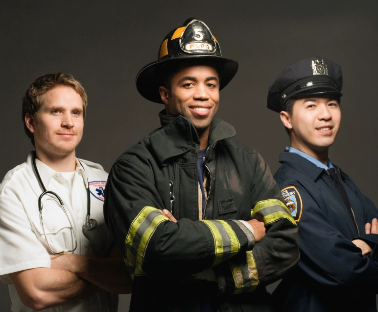 Three professionals: a doctor, firefighter, and police officer standing confidently.